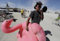 <p>Burning Man participant Joshua “Kanizzle” Cunningham of Burning Man Information Radio gives a running commentary with a megaphone on people’s costumes or lack thereof as approximately 70,000 people from all over the world gathered for the 1st full day of the annual Burning Man arts and music festival in the Black Rock Desert of Nevada, Aug. 28, 2017. (Photo: Jim Bourg/Reuters) </p>