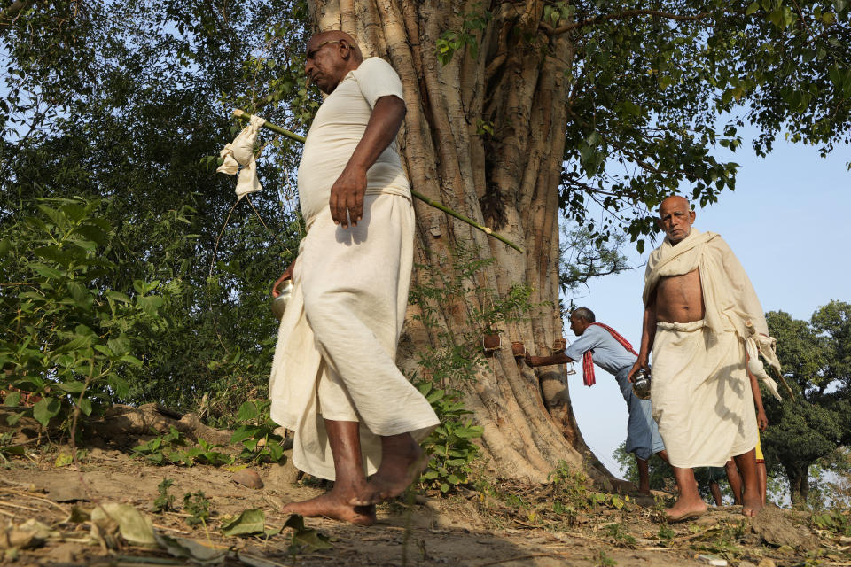 Relatives perform the last rites of three villagers who died due to heat related ailments in Ballia district, Uttar Pradesh state, India, Monday, June 19, 2023. Several people have died in two of India's most populous states in recent days amid a searing heat wave, as hospitals find themselves overwhelmed with patients. More than hundred people in the Uttar Pradesh state, and dozens in neighboring Bihar state have died due to heat-related illness. (AP Photo/Rajesh Kumar Singh)