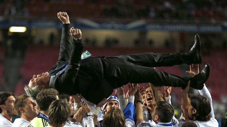Real&#39;s coach Carlo Ancelotti, is lifted in the air, after his team won the Champions League final soccer match between Atletico Madrid and Real Madrid in Lisbon, Portugal, Saturday, May 24, 2014. (AP Photo/Andres Kudacki, File)