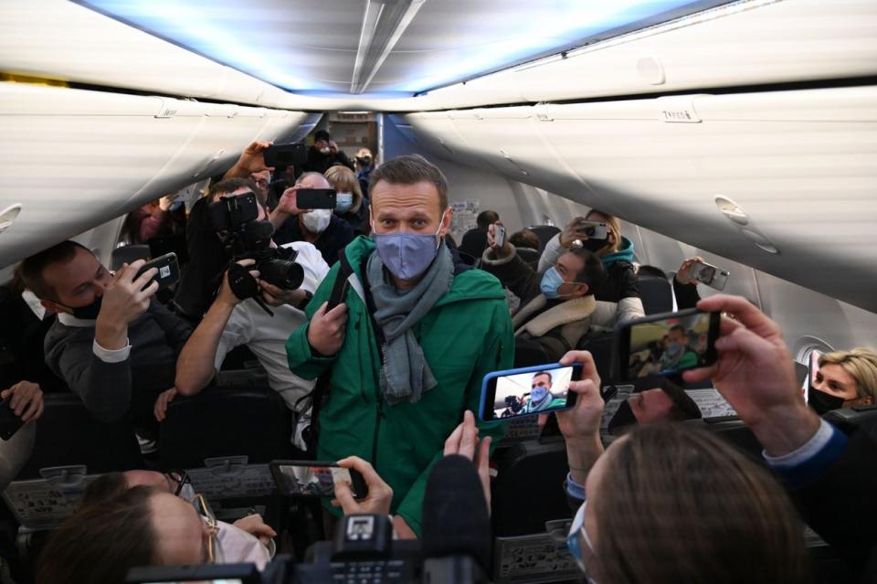 Russian opposition leader Alexei Navalny walks to take his seat in a Pobeda airlines plane heading to Moscow before take-off from Berlin Brandenburg Airport (BER) in Schoenefeld, southeast of Berlin, on Jan. 17, 2021. (Kirill Kudryavtsev /AFP via Getty Images)