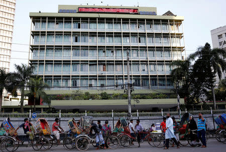 FILE PHOTO: Commuters walk in front of the Bangladesh central bank building in Dhaka, Bangladesh, September 30, 2016. REUTERS/Mohammad Ponir Hossain/File Photo