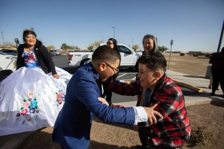 Memito and his cousin grab each other in excitement as they are promised a treat at the end of conclusion of Karina’s quinceañera Mass.