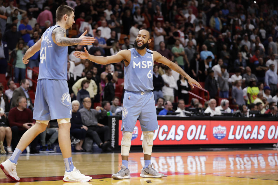 Minnesota Timberwolves guard Jordan McLaughlin (6) and forward Juancho Hernangomez (41) celebrate in the final seconds of the second half of an NBA basketball game against the Miami Heat, Wednesday, Feb. 26, 2020, in Miami. (AP Photo/Wilfredo Lee)