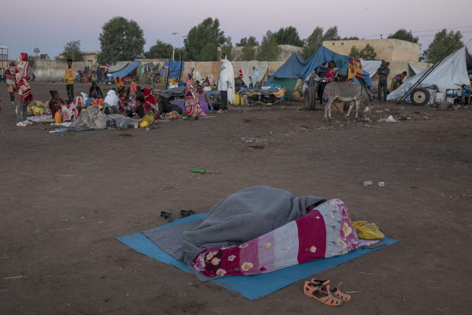 Tigray refugees who fled the conflict in the Ethiopia's Tigray take shelter at Hamdeyat Transition Center near the Sudan-Ethiopia border, eastern Sudan, Thursday, Dec. 3, 2020. Ethiopian forces on Thursday blocked people from the country's embattled Tigray region from crossing into Sudan at the busiest crossing point for refugees, Sudanese forces said.(AP Photo/Nariman El-Mofty)