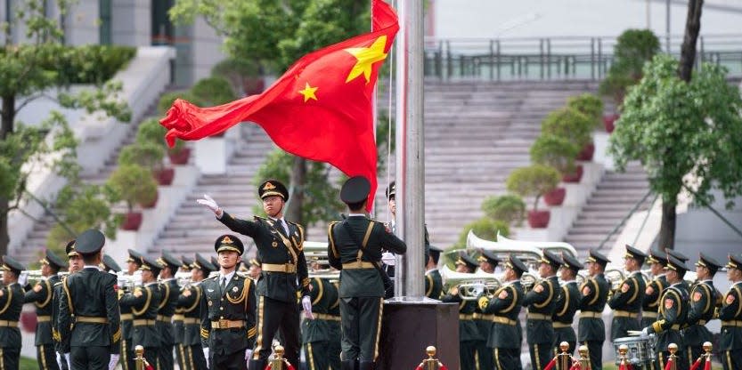 Soldiers of the Chinese People's Liberation Army Garrison stationed in the Macao Special Administrative Region attend a national flag-raising ceremony.