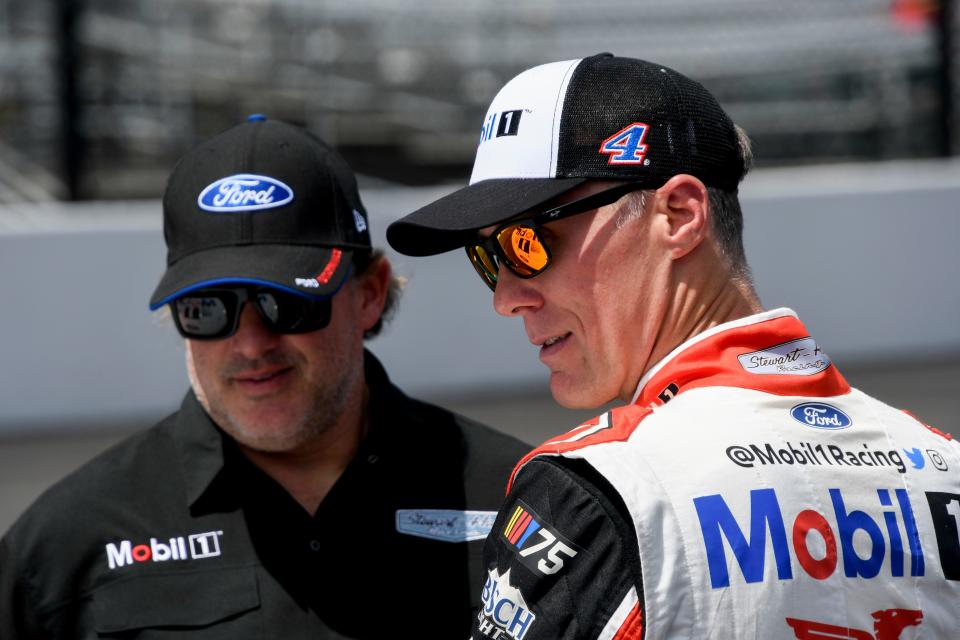 Tony Stewart (left) talks with Kevin Harvick at Indianapolis Motor Speedway last year.