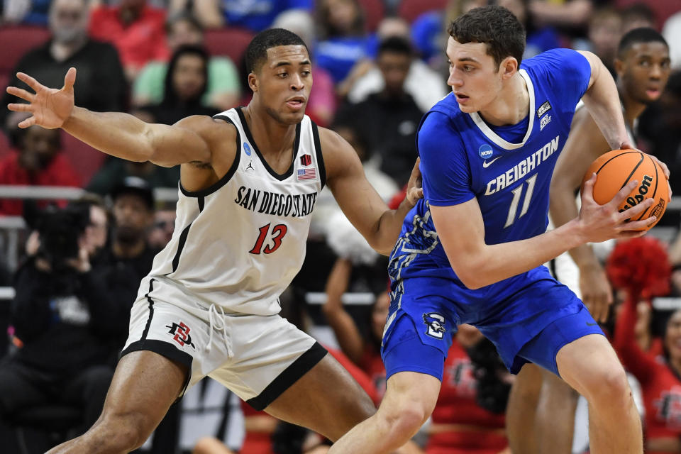 Creighton center Ryan Kalkbrenner (11) moves the ball against San Diego State forward Jaedon LeDee (13) in the first half of a Elite 8 college basketball game in the South Regional of the NCAA Tournament, Sunday, March 26, 2023, in Louisville, Ky. (AP Photo/Timothy D. Easley)