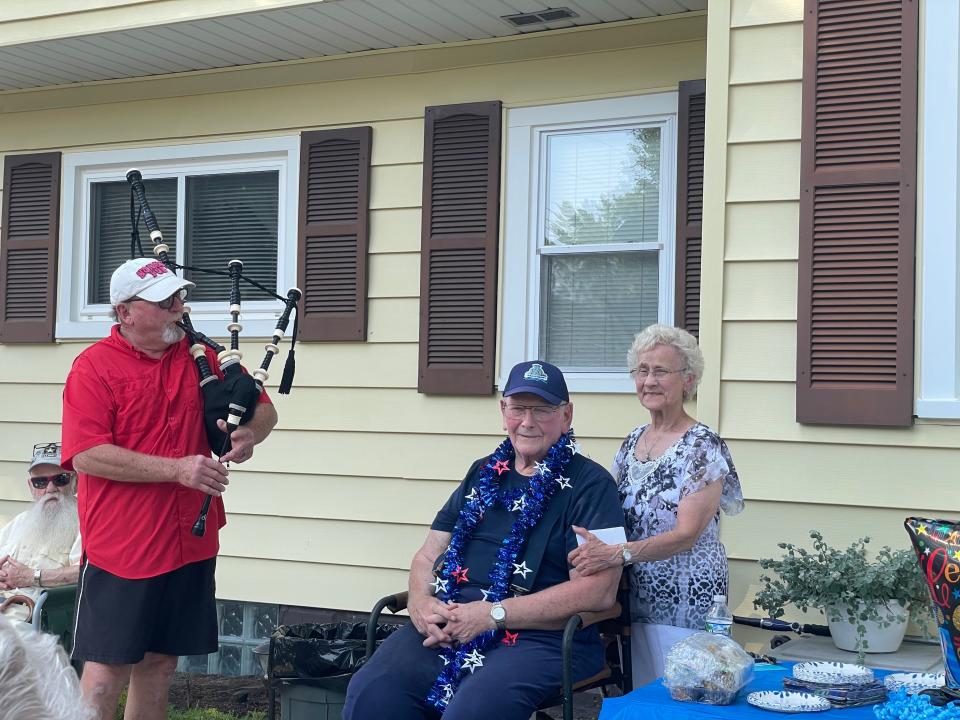 Larry Morrish and his wife, Verna Morrish, listening to Marysville council member Dave Barber play the bagpipes on June 17, 2024.