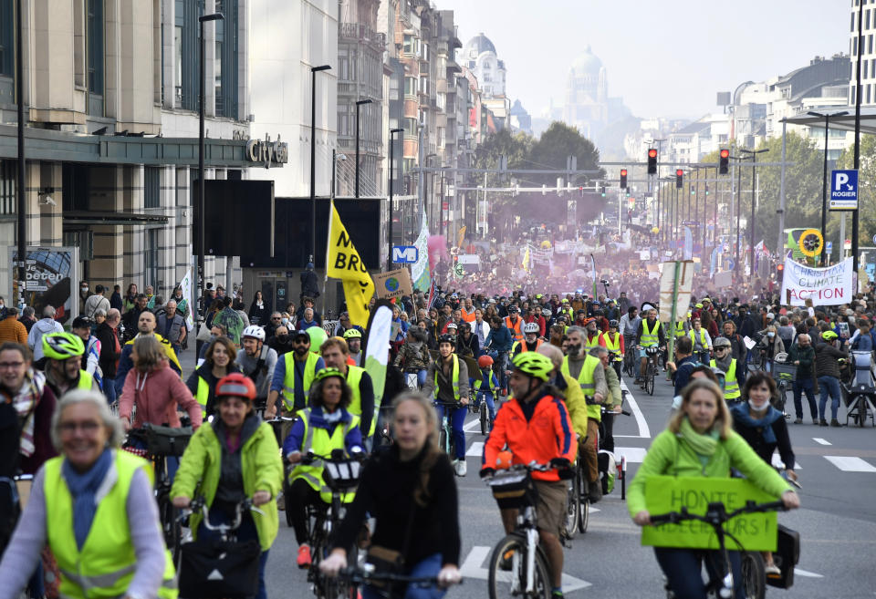 Cyclists participate in a climate march and demonstration in Brussels, Sunday, Oct. 10, 2021. Some 80 organizations are joining in a climate march through Brussels to demand change and push politicians to effective action in Glasgow later this month.(AP Photo/Geert Vanden Wijngaert)