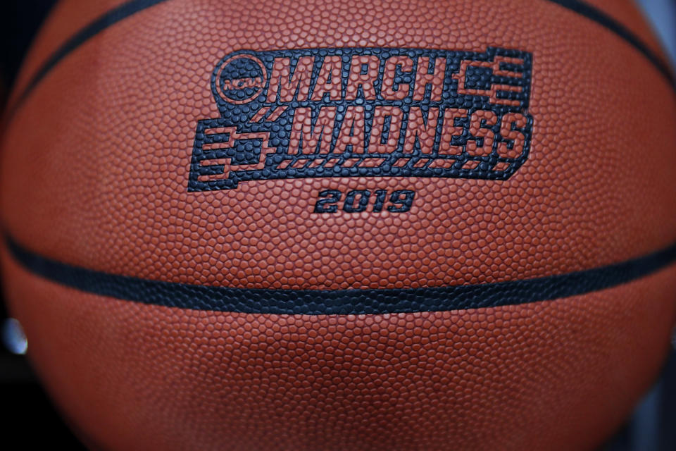 A basketball with a logo is seen before a first round men's college basketball game between Minnesota and Louisville in the NCAA Tournament, Thursday, March 21, 2019, in Des Moines, Iowa. (AP Photo/Charlie Neibergall)