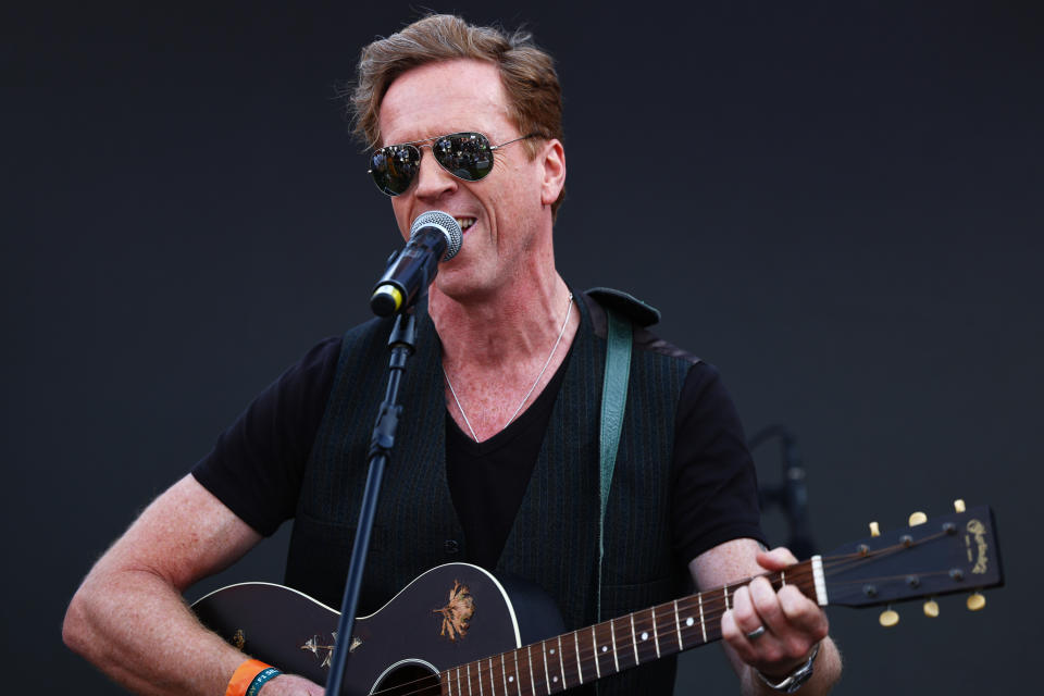 NORTHAMPTON, ENGLAND - JULY 08: Damian Lewis performs in the Paddock after qualifying ahead of the F1 Grand Prix of Great Britain at Silverstone Circuit on July 08, 2023 in Northampton, England. (Photo by Mark Thompson/Getty Images)