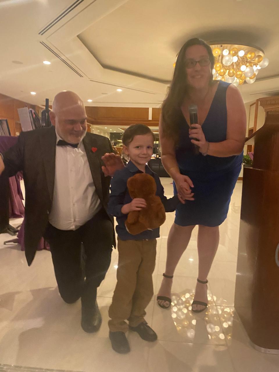 Dick Biermann joins Cameron Bryant and his mother, Alyssa Parks-Bryant, for a photo op at the Big Hearts for Little Hearts Desert Guild Chapter 20th anniversary celebration on April 2, 2022.