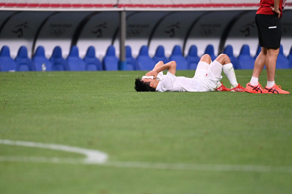 Japan's forward Takefusa Kubo cries following their defeat in the Tokyo 2020 Olympic Games men's bronze medal football match between Mexico and Japan at Saitama Stadium in Saitama on August 6, 2021. (Photo by Jonathan NACKSTRAND / AFP) (Photo by JONATHAN NACKSTRAND/AFP via Getty Images)