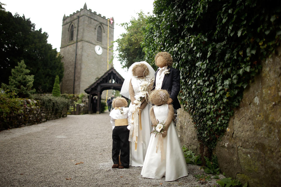 Scarecrows dressed as a bridal party stand as part of the annual scarecrow festival on August 13.