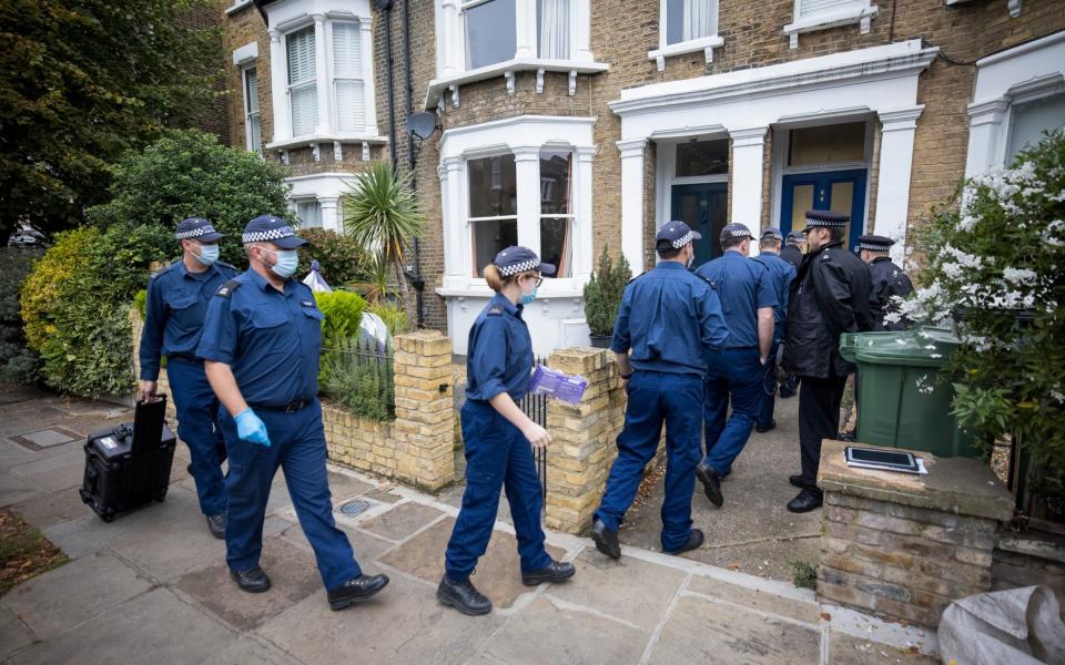 A police search team enters the most recent address of Ali Harbi Ali, in Kentish Town, north London