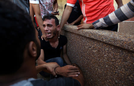 A relative of Palestinians who were killed at the Israel-Gaza border, reacts in the southern Gaza Strip September 18, 2018. REUTERS/Ibraheem Abu Mustafa