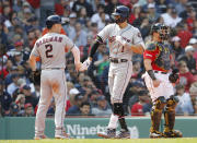 Houston Astros' Carlos Correa is greeted by Alex Bregman (2) after his two-run home run as Boston Red Sox catcher Christian Vazquez looks on during the third inning of a baseball game against the Boston Red Sox, Sunday, May 19, 2019, at Fenway Park in Boston. (AP Photo/Winslow Townson)