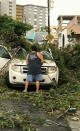 <p>A man removes debris from a car following high winds as Hurricane Irma nears San Juan, Puerto Rico, Sept. 6, 2017, in this image taken from social media. (Photo: Nicole Pellot/Handout via Reuters) </p>