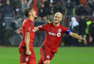 <p>Nick Hagglund #6 of Toronto FC celebrates a goal with Michael Bradley #4 during the second half of the MLS Eastern Conference Final, Leg 2 game against Montreal Impact at BMO Field on November 30, 2016 in Toronto, Ontario, Canada. (Photo by Vaughn Ridley/Getty Images) </p>