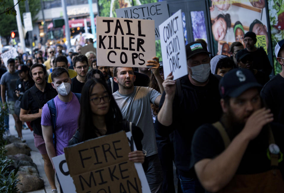 Protesters march through downtown Seattle after body camera footage was released of a Seattle police officer joking about the death of Jaahnavi Kandula, a 23-year-old woman hit and killed in January by officer Kevin Dave in a police cruiser, Thursday, Sept. 14, 2023, in Seattle. (AP Photo/Lindsey Wasson)