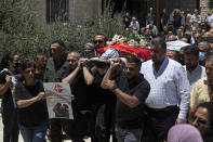 Palestinian mourners carry the body of Suha Jarrar, 30-year-old daughter of Khalida Jarrar, who is a prisoner in an Israeli jail, during her funeral, in the West Bank city of Ramallah, Tuesday, July 13, 2021. Khalida Jarrar, 58, a leading member of the Popular Front for the Liberation of Palestine, has been in and out of Israeli prison in recent years. Palestinian activists and human rights groups urged Israel to allow Jarrar to attend her daughter’s funeral. (AP Photo/Majdi Mohammed)