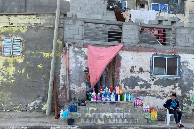 Palestinian boy sells cleaning tools and sanitizers in Gaza City