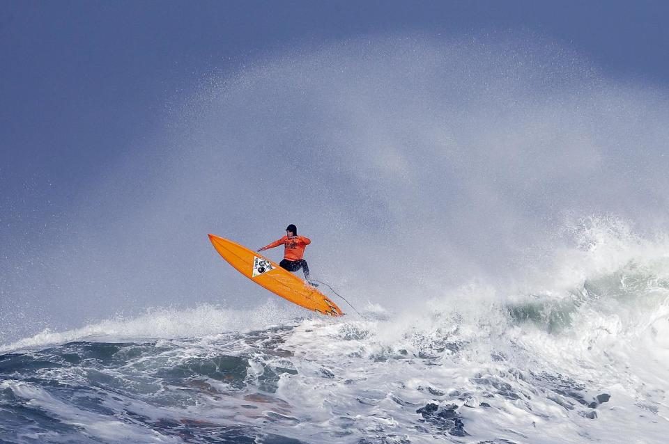 Tyler Fox flies out of a wave during the second heat of the first round of the Mavericks Invitational big wave surf contest Friday, Jan. 24, 2014, in Half Moon Bay, Calif. (AP Photo/Eric Risberg)