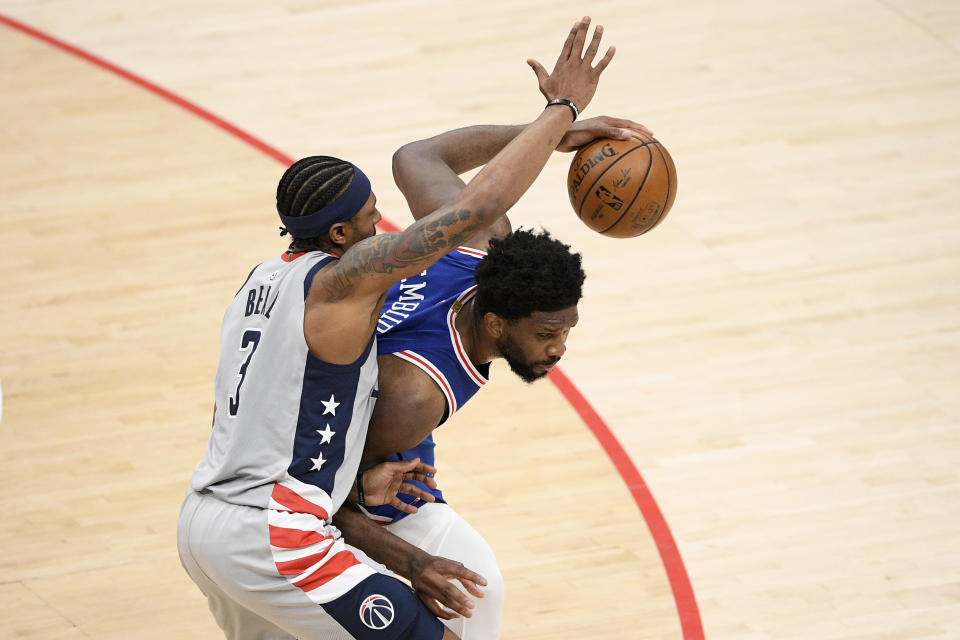 Philadelphia 76ers center Joel Embiid, right, dribbles against Washington Wizards guard Bradley Beal (3) during the second half of Game 3 in a first-round NBA basketball playoff series, Saturday, May 29, 2021, in Washington. (AP Photo/Nick Wass)