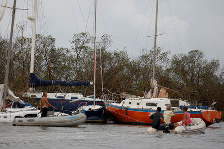 People look at the damaged boats after the area was hit by Hurricane Maria in Salinas, Puerto Rico September 21, 2017. REUTERS/Carlos Garcia Rawlins