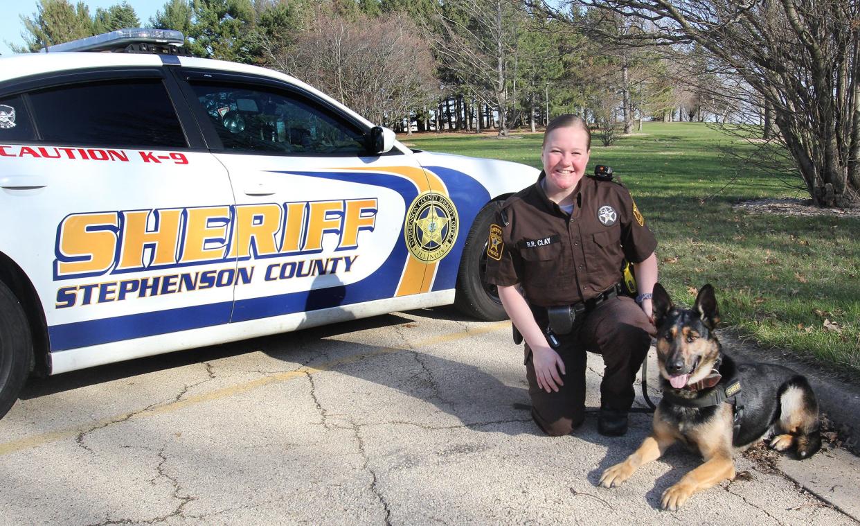 Stephenson County Sheriff Deputy Rachel Clay kneels next to K-9 Officer Ralf on Thursday, April 21, 2022, at Highland Community College in Freeport. Clay is the first female K-9 officer for the Stephenson County Sheriff Department.