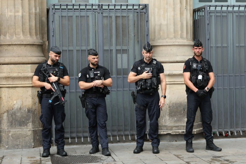 French Police stand outside the main Gare Du Nord train station after an arson attack caused mayhem and delays to the train network and Eurostar in Paris on Friday. Photo by Hugo Philpott/UPI