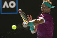 Rafael Nadal of Spain plays a forehand return to Marcos Giron of the U.S. during their first round match at the Australian Open tennis championships in Melbourne, Australia, Monday, Jan. 17, 2022. (AP Photo/Hamish Blair)