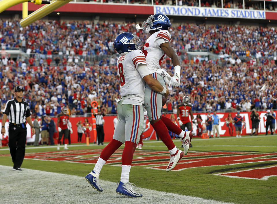 New York Giants quarterback Daniel Jones (8) celebrates his touchdown run against the Tampa Bay Buccaneers with wide receiver Darius Slayton (86) during the second half of an NFL football game Sunday, Sept. 22, 2019, in Tampa, Fla. (AP Photo/Mark LoMoglio)