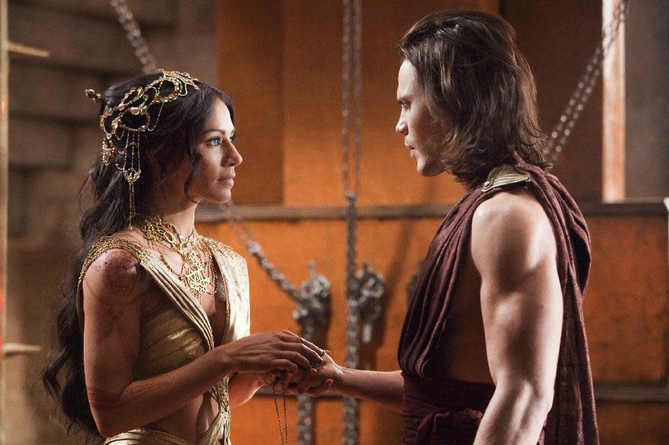 In this film image released by Disney, Lynn Collins portrays Dejah Thoris, left, and Taylor Kitsch portrays John Carter in a scene from "John Carter." (AP Photo/Disney, Frank Connor)