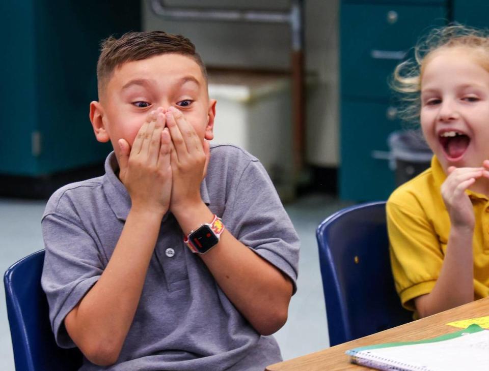 3rd grader Adrian Carrillo, left, reacts after getting the “No Homework” prize for accurately predicting Tyreek Hill’s receiving yards against the Bills (82 yards). Pinecrest Elementary 3rd grade teacher Mary Martinez used stats from this season’s Dolphins games as part of her lesson plan for her students during class on Monday, January 8, 2024, in Pinecrest, Florida.