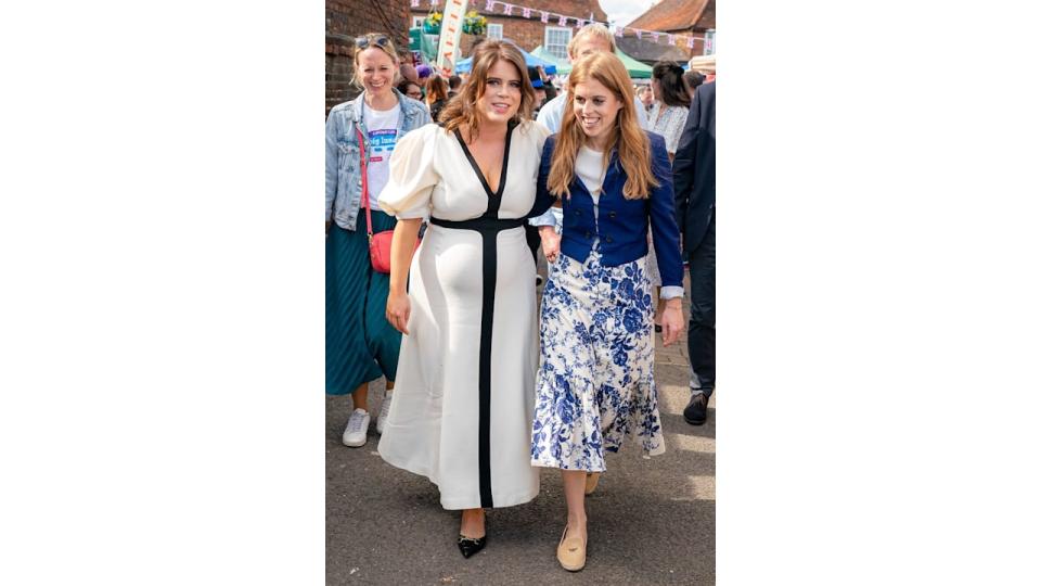 Beatrice and Eugenie smiling at coronation street party