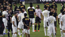 Players from Inter Miami and Atlanta United gather on the field before a scheduled MLS soccer match, Wednesday, Aug. 26, 2020, in Fort Lauderdale, Fla. Major League Soccer players boycotted five games Wednesday night in a collective statement against racial injustice. The players' action comes after all three NBA playoff games were called off in a protest over the shooting of Jacob Blake in Wisconsin on Sunday night. (AP Photo/Jim Rassol)