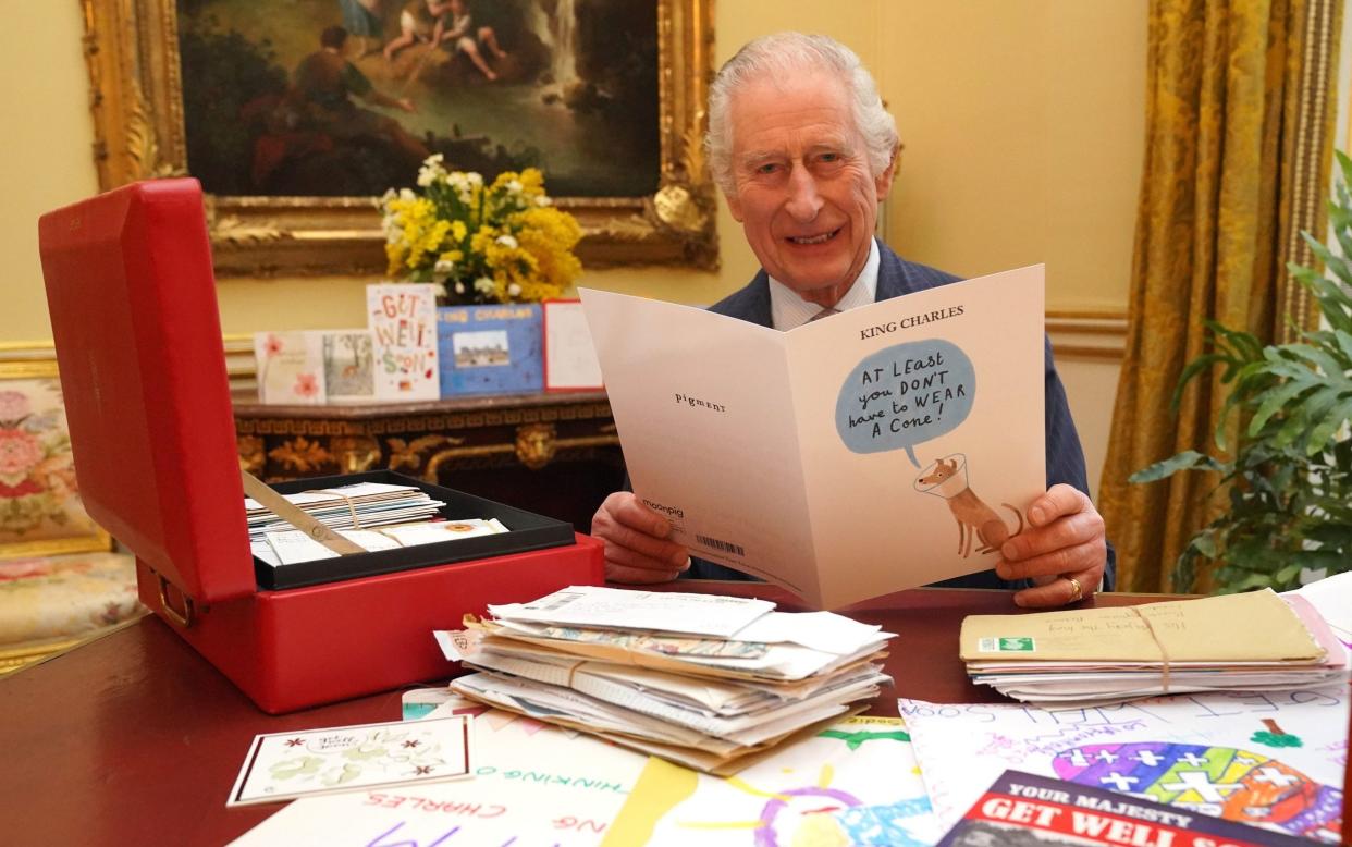 King Charles III pictured in February reading cards and messages sent by wellwishers following his cancer diagnosis