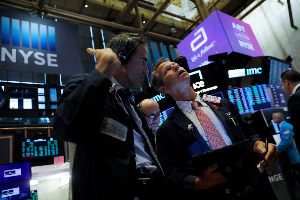 Traders work on the trading floor at the New York Stock Exchange (NYSE) at the opening of the market in New York City, U.S., August 26, 2019. REUTERS/Andrew Kelly