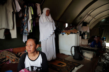 A woman prays at her temporary shelter for people whose homes were demolished during eviction by the city authorities at Luar Batang district in Jakarta, Indonesia, November 11, 2016. REUTERS/Beawiharta