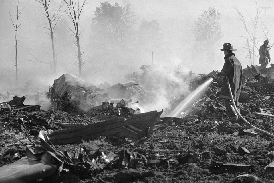 FILE - In this May 25, 1979 file photo, a fireman hoses down twisted remains of an American Airlines DC-10 which crashed and exploded on takeoff from O'Hare International Airport, in Chicago. Decades later, the crash of American Airlines Flight 191 moments after it took off from Chicago's O'Hare International Airport remains the deadliest aviation accident in U.S. history. The DC-10 was destined for Los Angeles when it lost one of its engines killing what investigators later determined were 273 people _ all 271 people aboard the jetliner and two people on the ground. (AP Photo/Fred Jewell File)