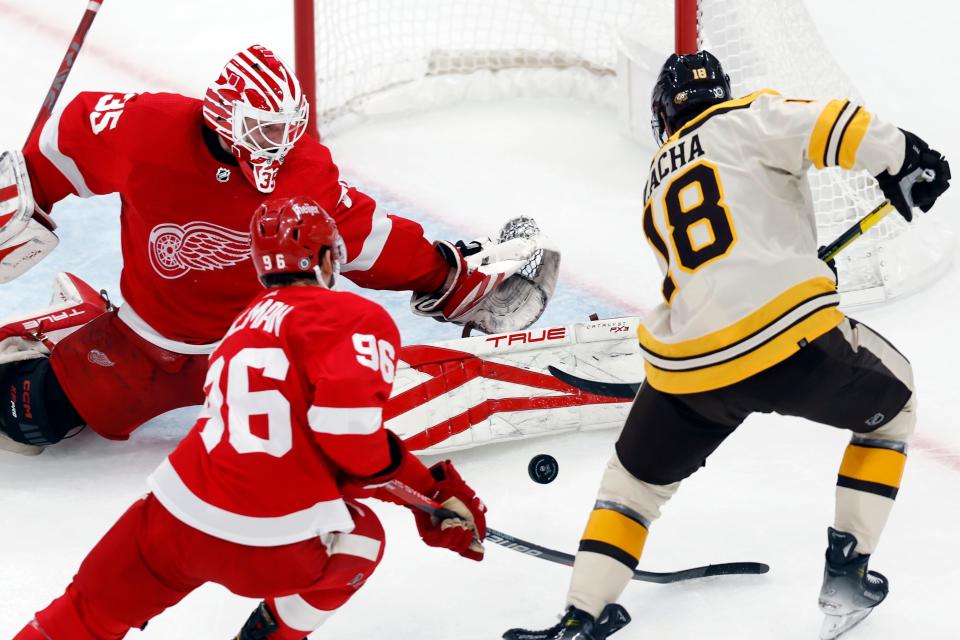 Detroit Red Wings' Ville Husso (35) blocks a shot by Boston Bruins' Pavel Zacha (18) during the first period at TD Garden in Boston on Saturday, Oct. 28, 2023.