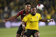 Columbus Crew's Steven Moreira, right, and Atlanta United's Caleb Wiley, left, chase after the ball in the first half of an MLS playoff soccer match Wednesday, Nov. 1, 2023, in Columbus, Ohio. (AP Photo/Sue Ogrocki)