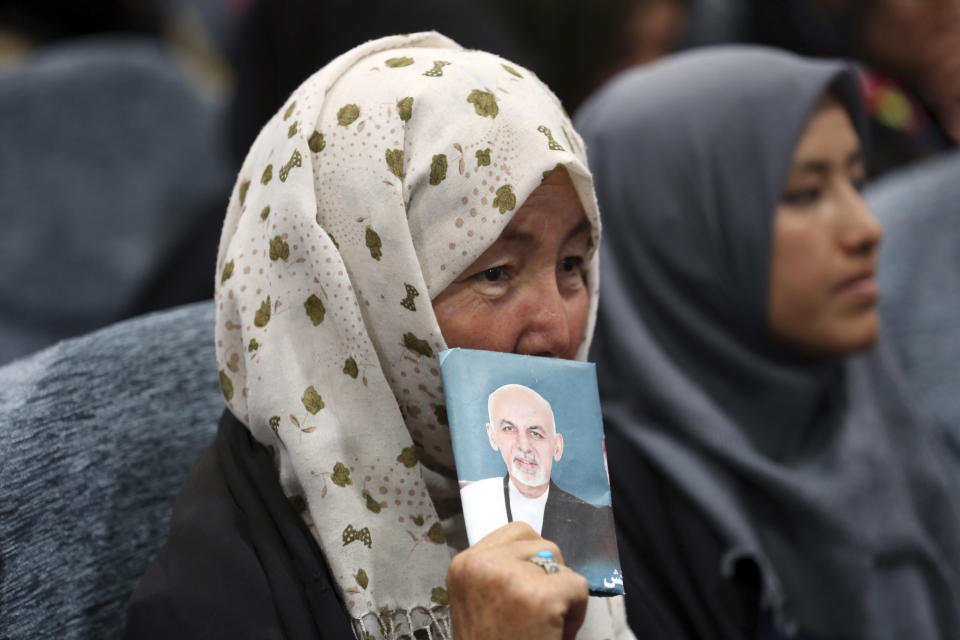 A supporter holding an image of Afghan presidential candidate Ashraf Ghani attends the first day of campaigning in Kabul, Afghanistan, Sunday, July 28, 2019. Sunday marked the first day of campaigning for presidential elections scheduled for Sept. 28. President Ghani is seeking a second term on promises of ending the 18-year war but has been largely sidelined over the past year as the U.S. has negotiated directly with the Taliban. (AP Photo/Rahmat Gul)