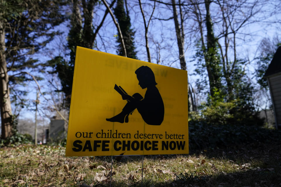 A sign that reads "our children deserve better safe choice now" is seen on Friday, Jan. 15, 2021, in Decatur, Ga. Just down the road from the U.S. Centers for Disease Control and Prevention, in a community flush with resident health professionals, the Decatur school system had no shortage of expert input on whether to resume in-person classes amid the coronavirus pandemic. Scores of public health and medical professionals from the affluent, politically liberal Atlanta suburb have weighed in about what's best for their own kids’ schools.(AP Photo/Brynn Anderson)