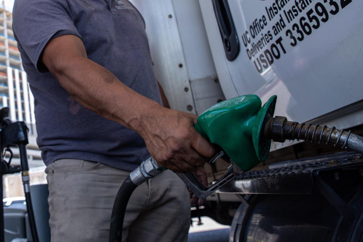 Richard Ortega fills up the tank at a gas station in downtown Phoenix, Arizona, in July.