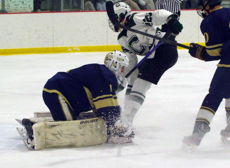 Archbishop Williams goalie Sean Velozo, of Raynham, makes a big stop in the OT period during the Bishops' 4-3 win over Canton at Canton Metro Ice Arena on Wednesday, Jan. 17, 2024.