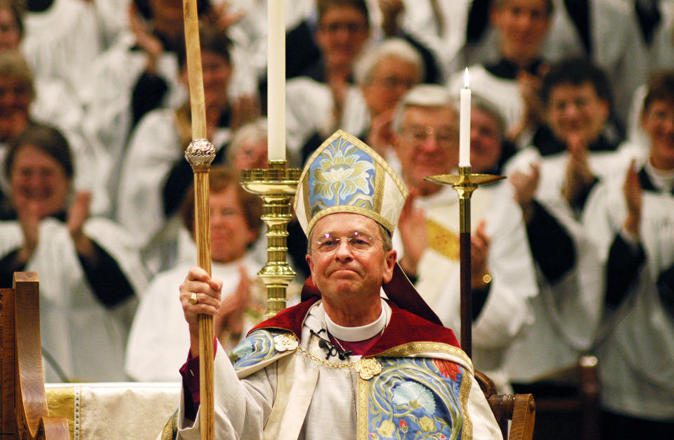 FILE - In this Sunday, March 7, 2004 file photo, Gene Robinson is applauded after his investiture as the Episcopal Church's bishop of New Hampshire at St. Paul's Church in Concord, N.H. When the United Methodist Church removed anti-LGBTQ language from its official rules in recent days, it marked the end of a half-century of debates over LGBTQ inclusion in mainline Protestant denominations. The moves sparked joy from progressive delegates, but the UMC faces many of the same challenges as Lutheran, Presbyterian and Episcopal denominations that took similar routes, from schisms to friction with international churches to the long-term aging and shrinking of their memberships. (AP Photo/Lee Marriner, File)