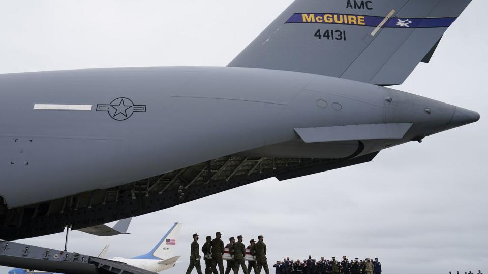 President Joe Biden, first lady Jill Biden, and Secretary of Defense Lloyd Austin and others watch as a carry team moves a transfer case with the remain of Marine Corps Lance Cpl. Dylan R. Merola, 20, of Rancho Cucamonga, Calif., during a casualty return at Dover Air Force Base, Del., Sunday, Aug. 29, 2021. According to the Department of Defense, Merola died in a suicide bombing at Afghanistan's Kabul airport, along with 12 other U.S. service members. (AP Photo/Carolyn Kaster)