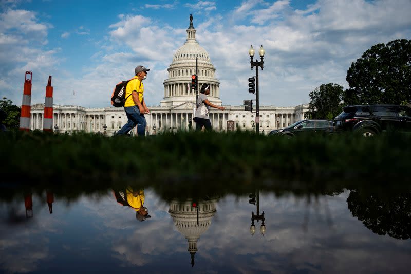 A man walks past the U.S. Capitol building in Washington